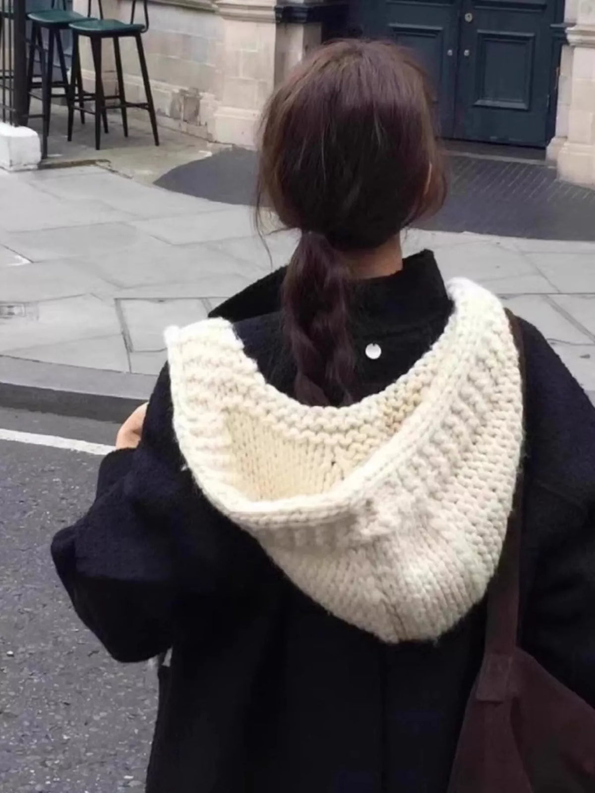 Rebellious Gal model wearing one-piece knitted hood scarf hat layered over leather jacket