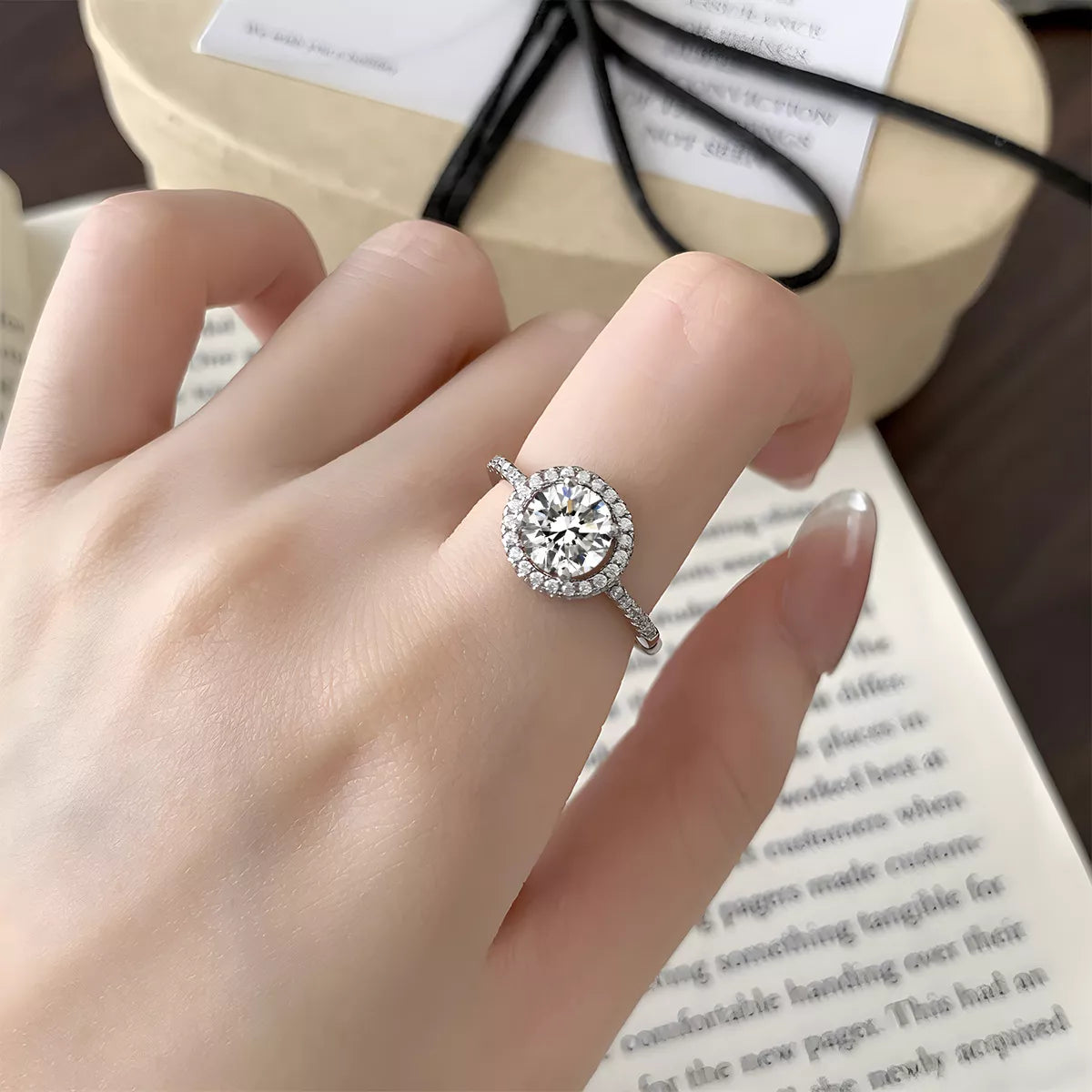 On-model finger shot showing how the 1 carat moissanite ring sits elegantly