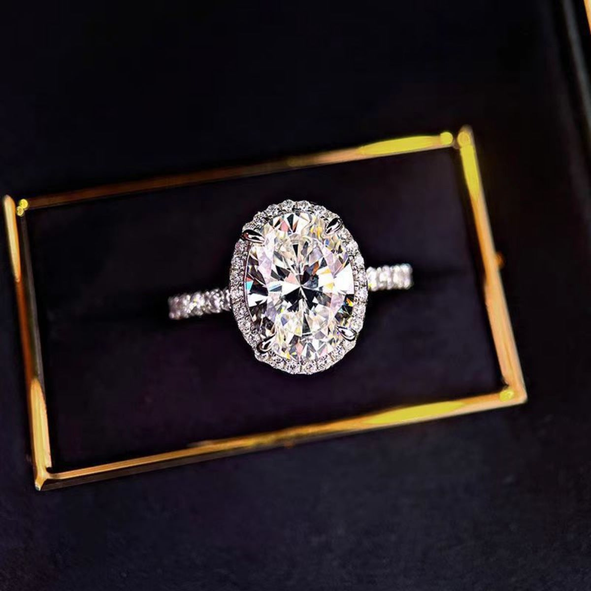 Close-up of brilliant 2ct oval moissanite stone in 925 sterling silver setting