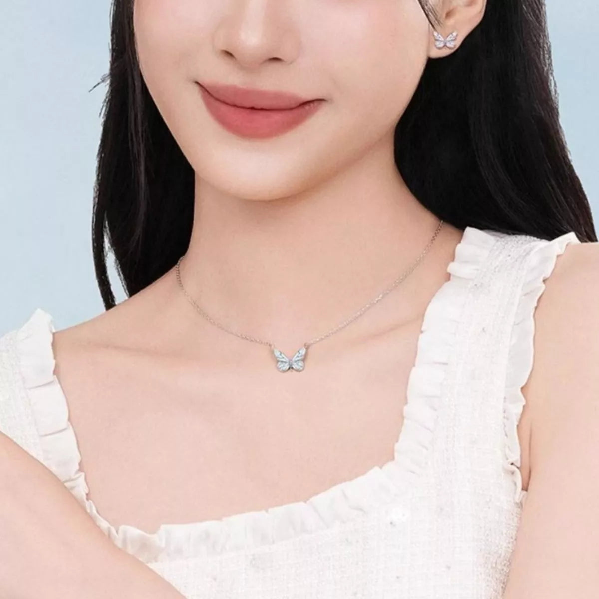 Model wearing Rebellious Gal butterfly necklace with rebellious layered look