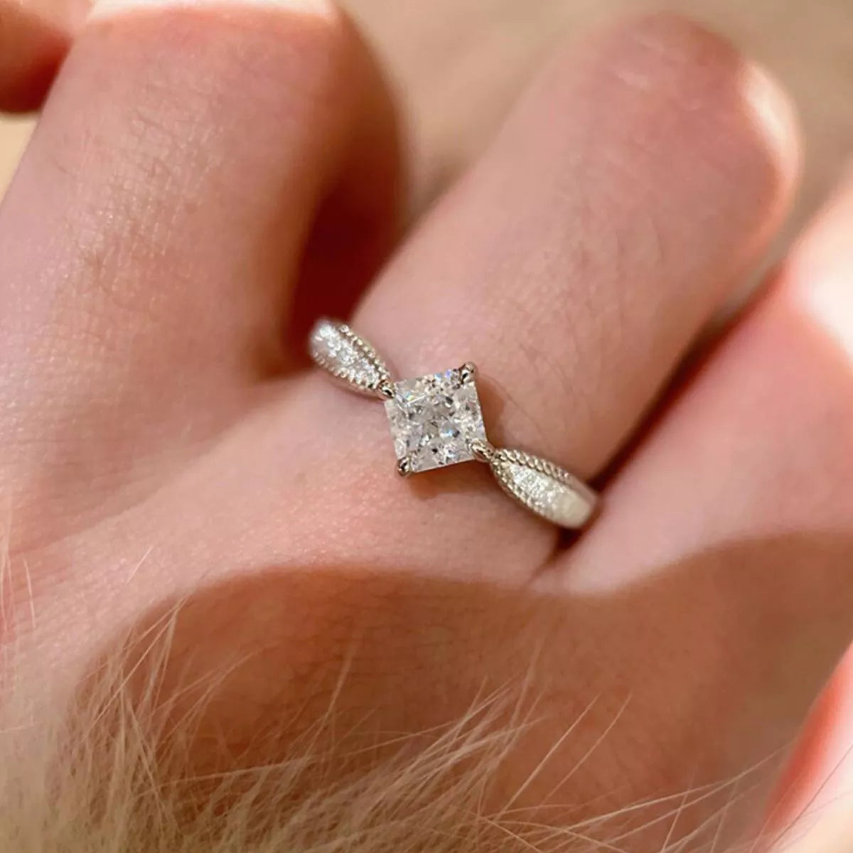 Close-up of a diamond ring on a finger
