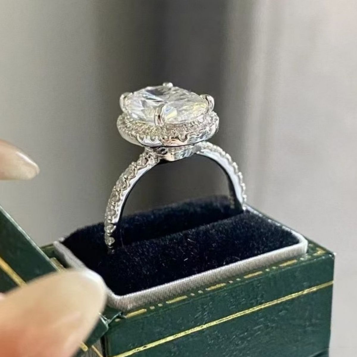 Close-up texture of 925 sterling silver band and secure oval moissanite setting
