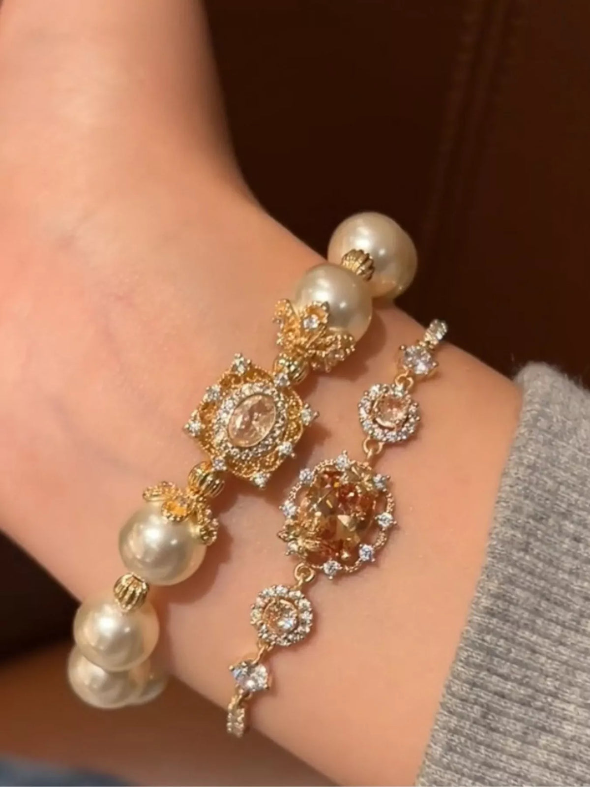 Elegant bracelet with pearls and gold accents on a wrist.