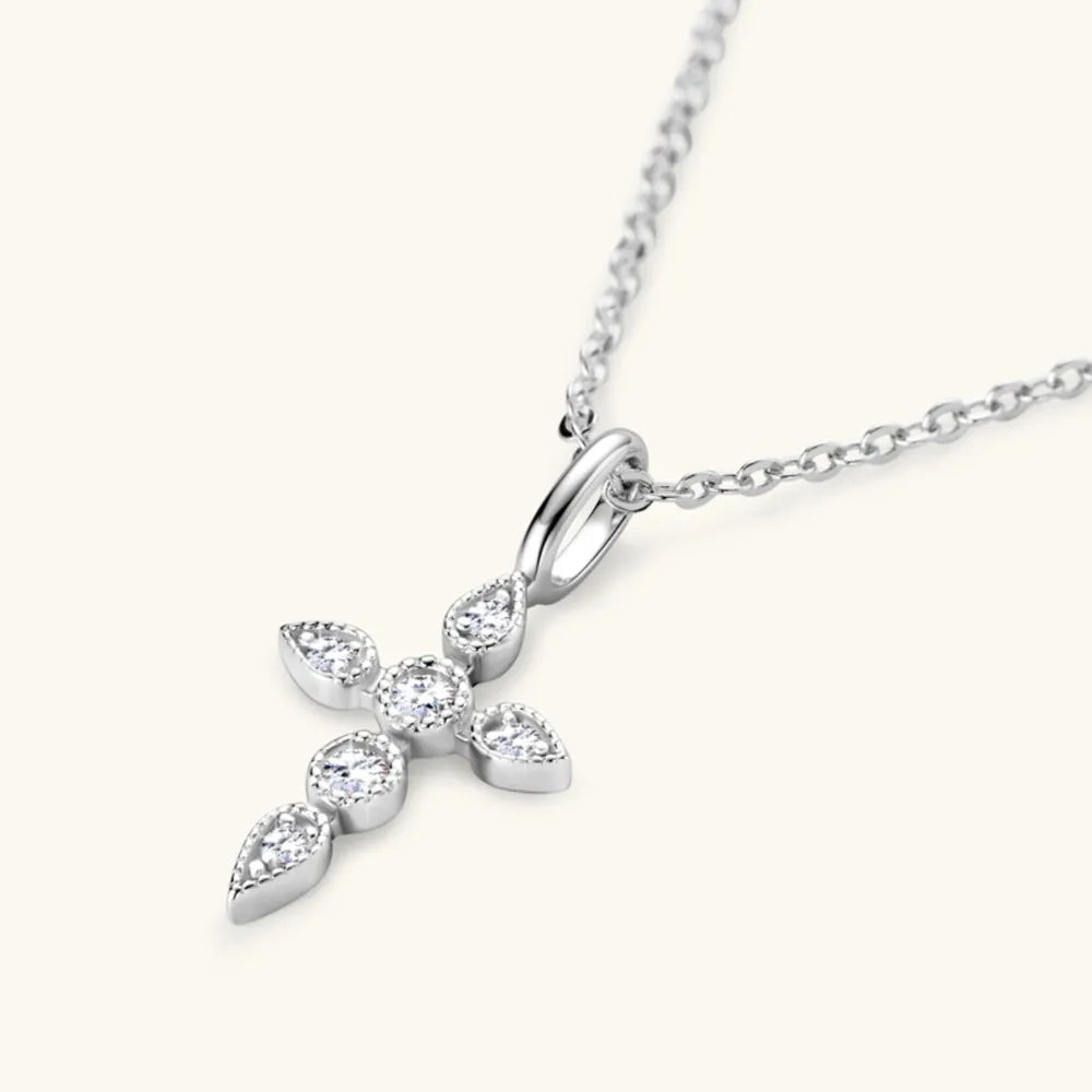 Model layering the cross necklace with other chains for bold rebellious styling