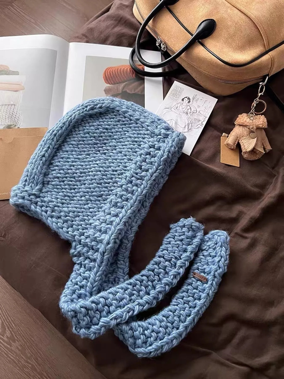 Hood pulled up on knitted hooded scarf hat for full coverage fierce winter look