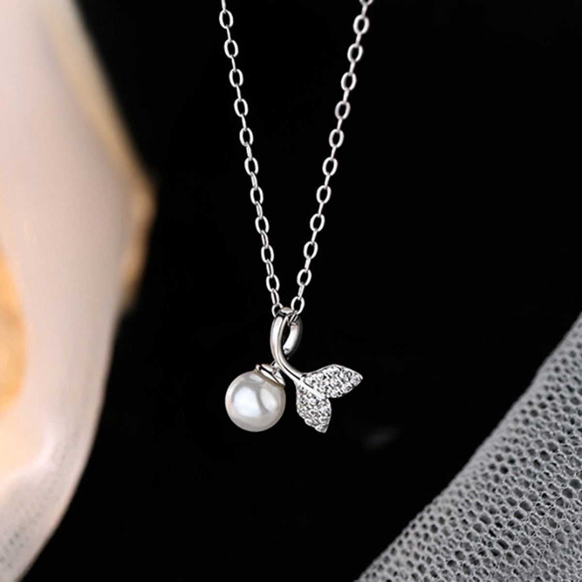 Close-up texture of 925 sterling silver chain and clasp on pearl necklace