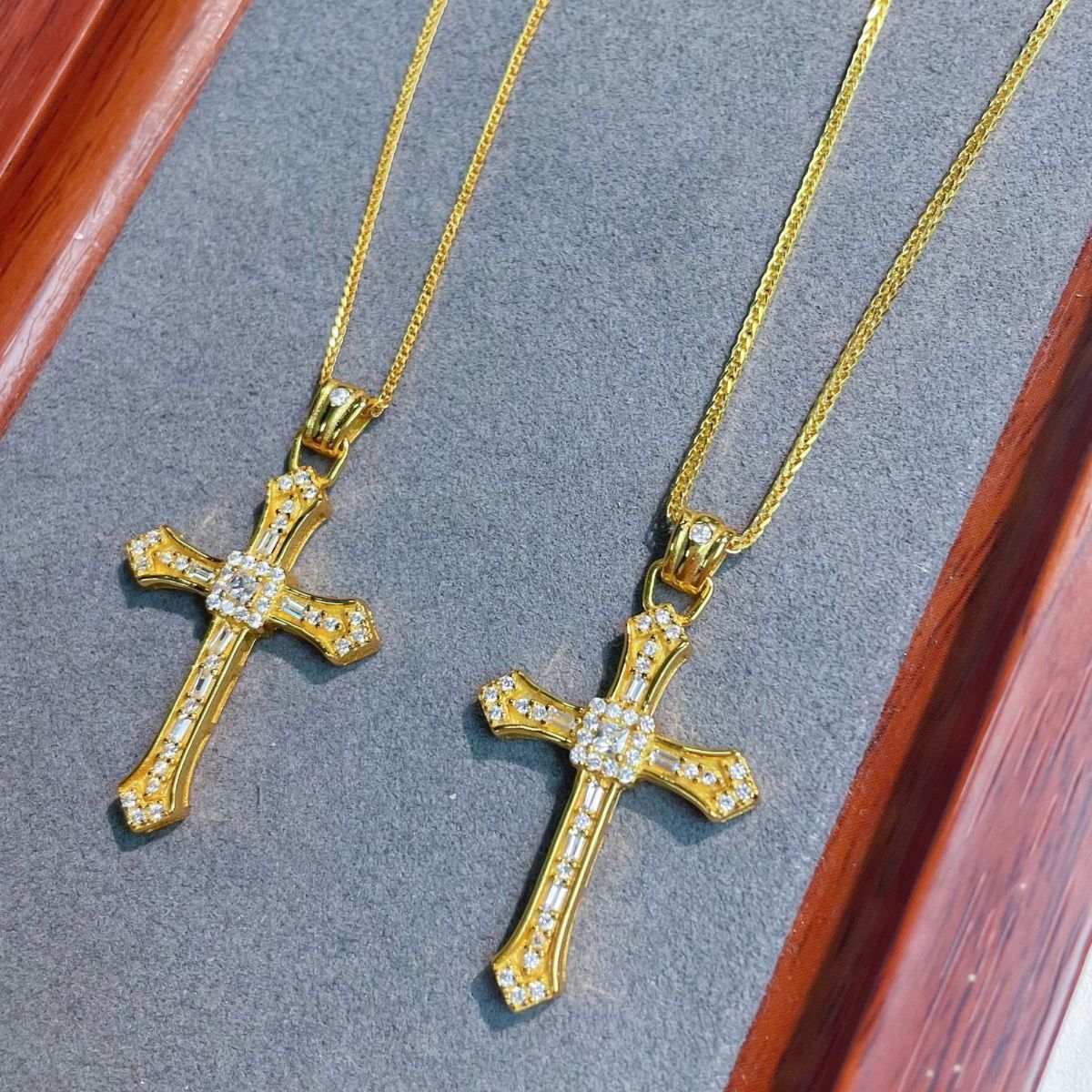 Gold plated cross necklace with shimmering zircon stones in light