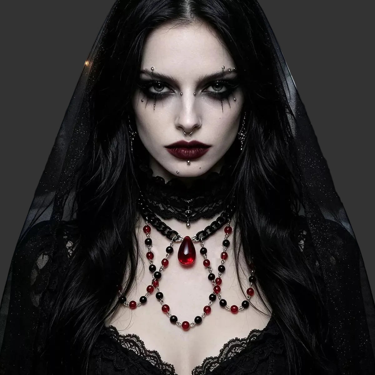 Red and black beaded choker with red teardrop pendant worn with a black lace veil