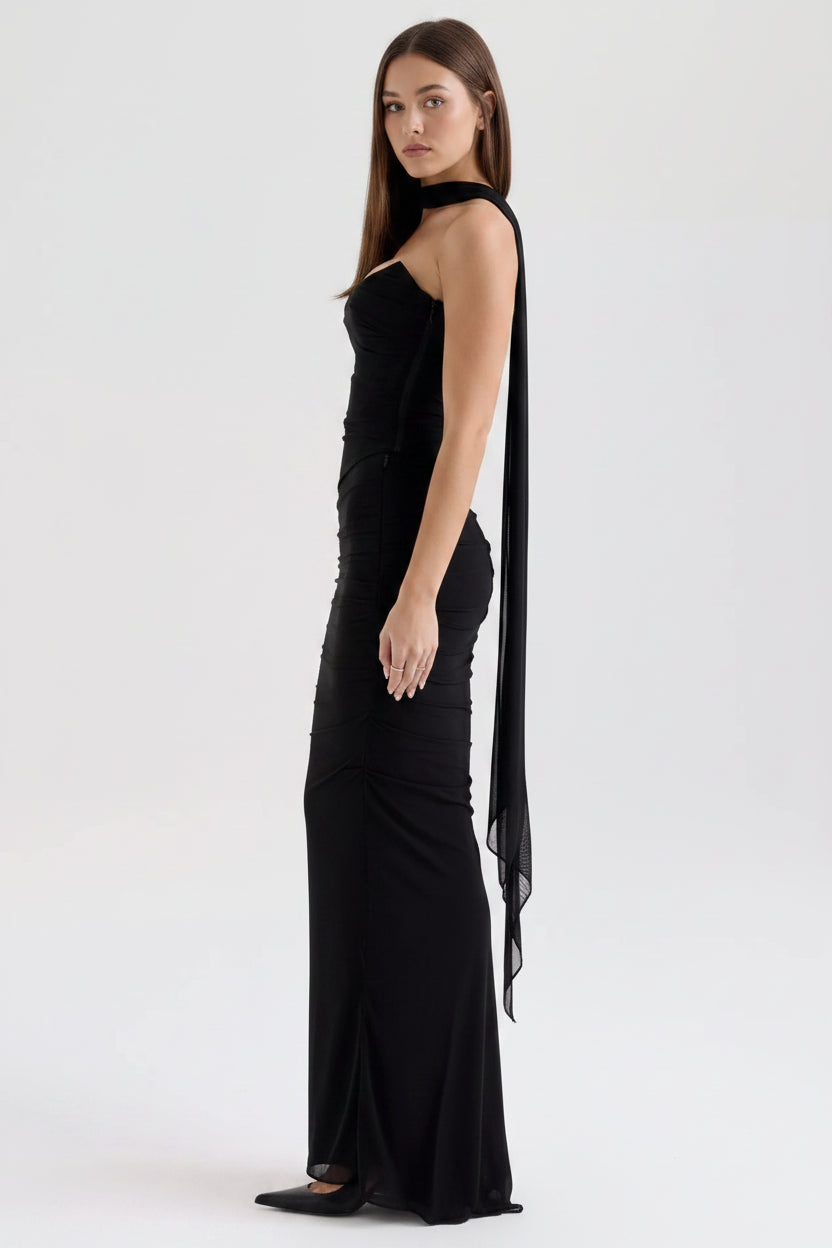 Black evening gown with sheer sides on a white background