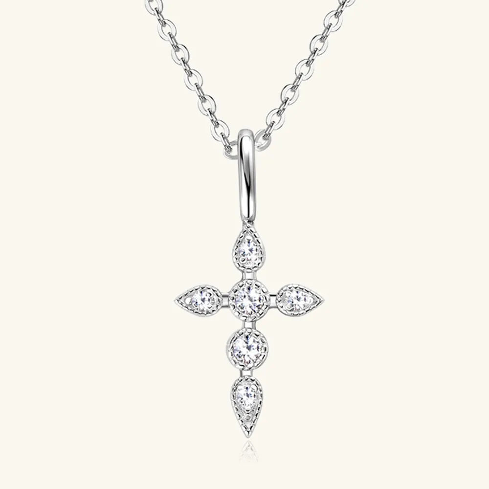 Flat lay of moissanite cross pendant necklace with matching luxury gift box