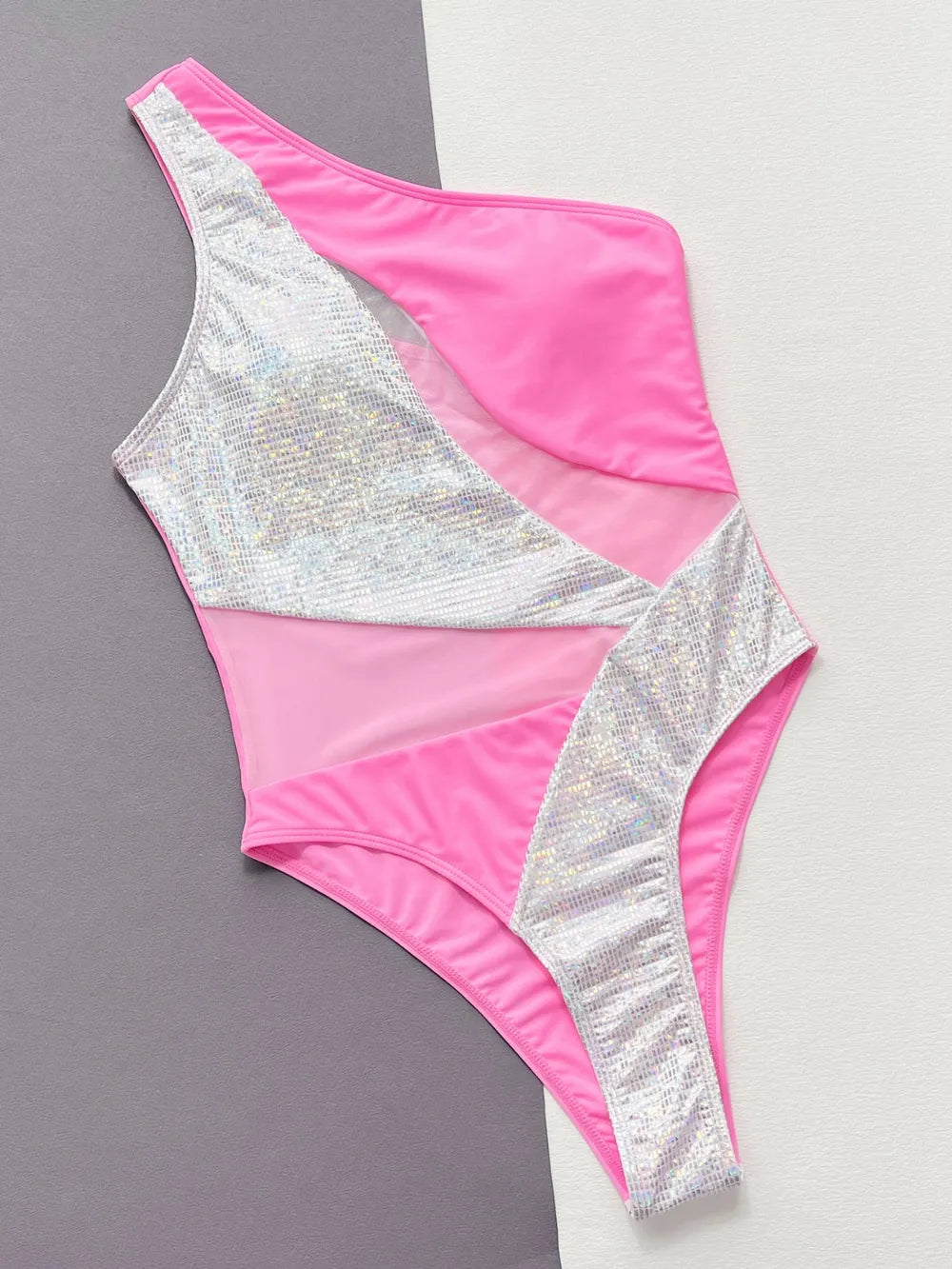 Hot pink swimsuit laid flat, front, silver sequin panels and sheer mesh insets, two-tone backdrop