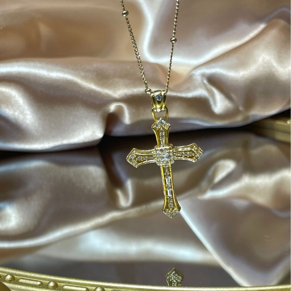 Close-up of sparkling zircon cross pendant in 18K gold-plated sterling silver