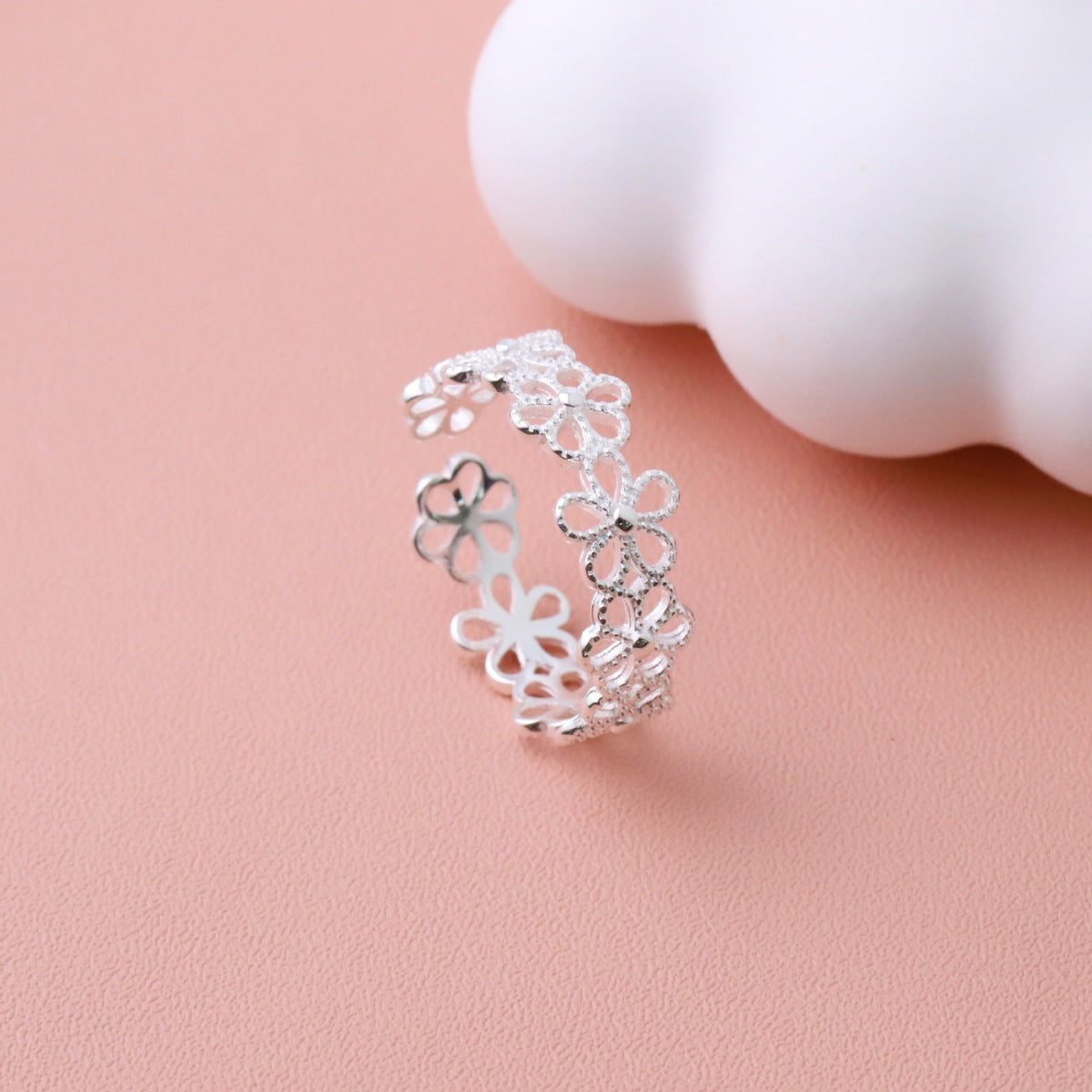 Close-up texture of etched floral details and smooth 925 sterling silver finish