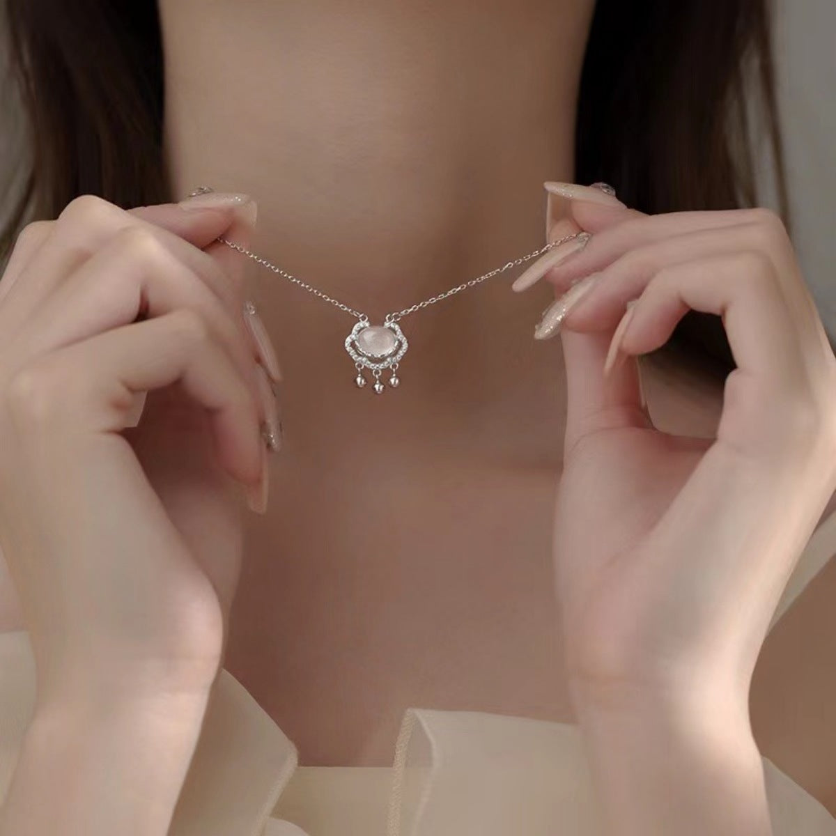 Model layering the auspicious lock necklace with other bold chains