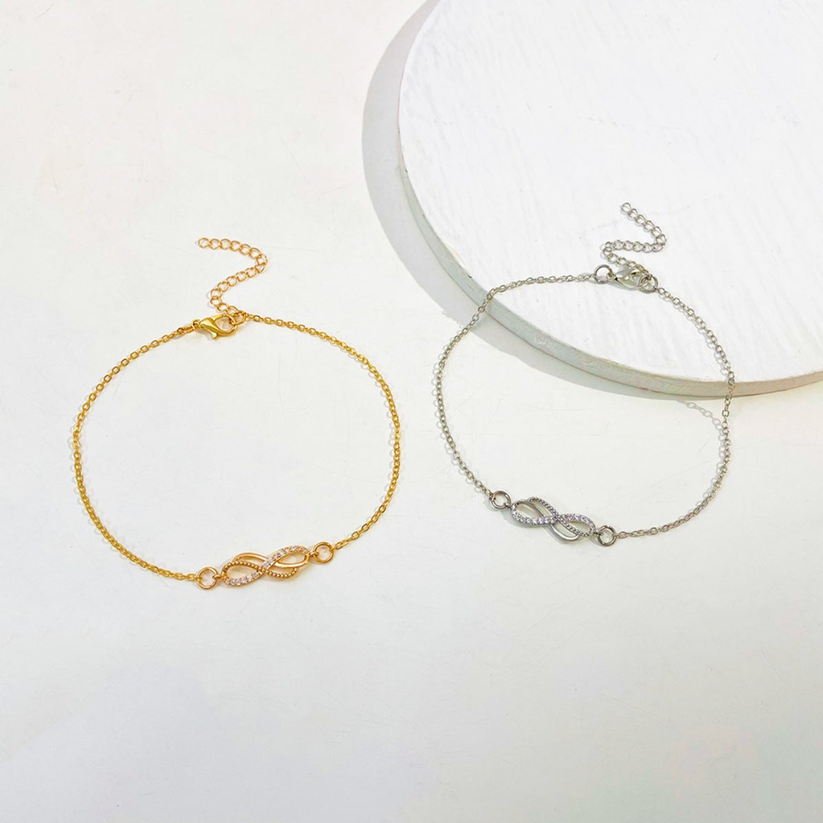 Side profile of delicate 6.3" infinity knot bracelet showing chain and charm