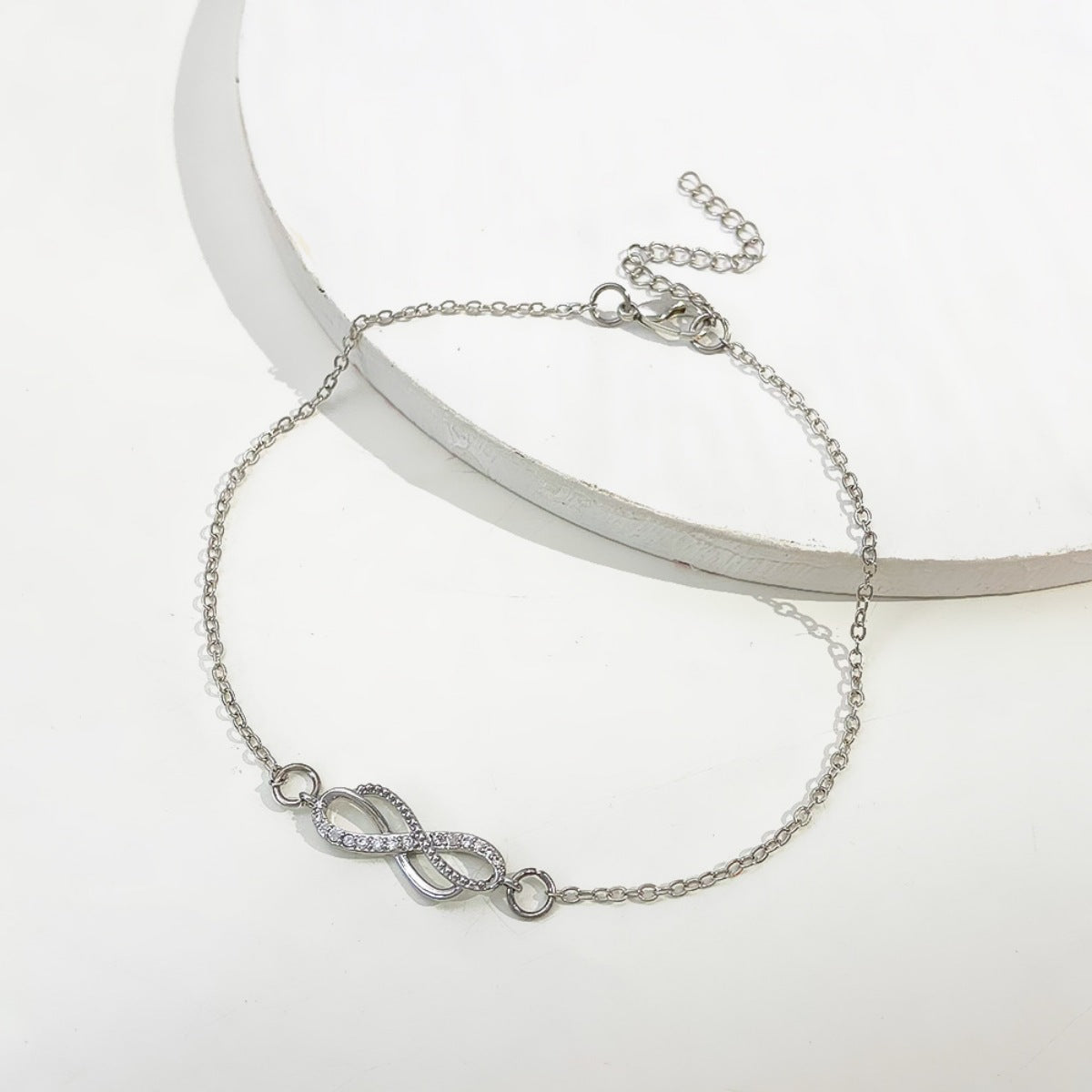 Close-up of infinity knot charm on 18K gold-plated sterling silver chain