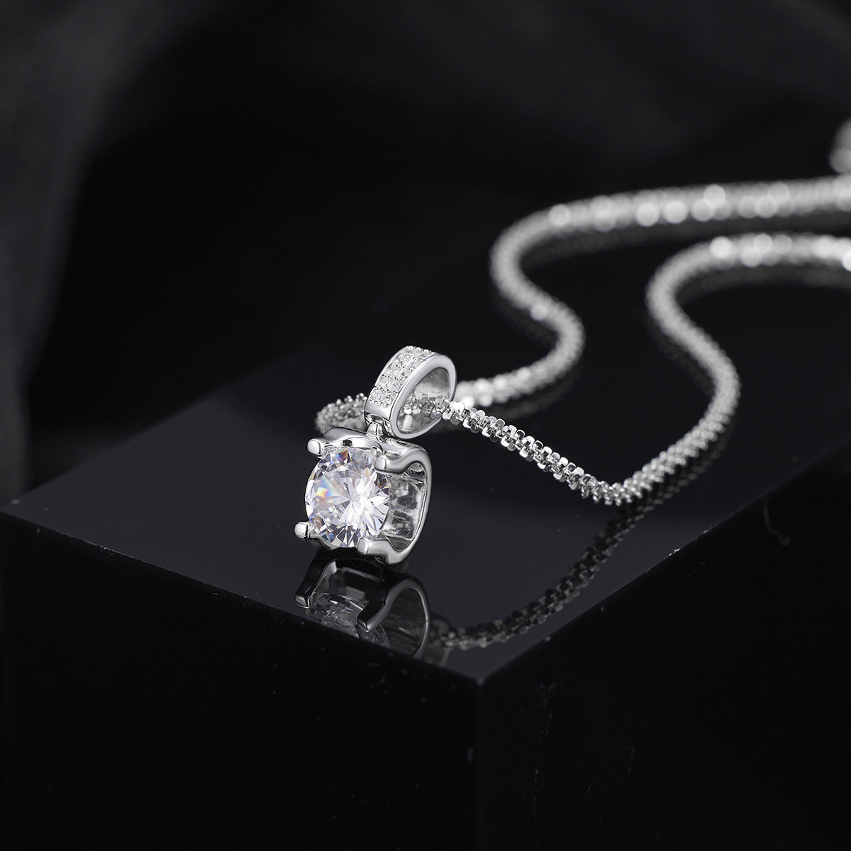 Close-up of sparkling zircon stone set in 925 sterling silver pendant