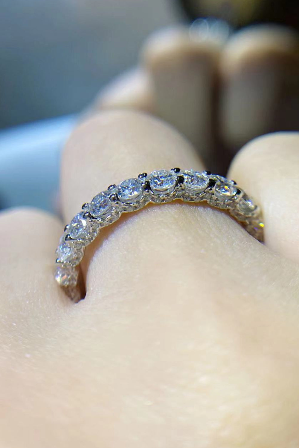 Overhead product shot of 1.5 carat moissanite ring emphasizing thin band