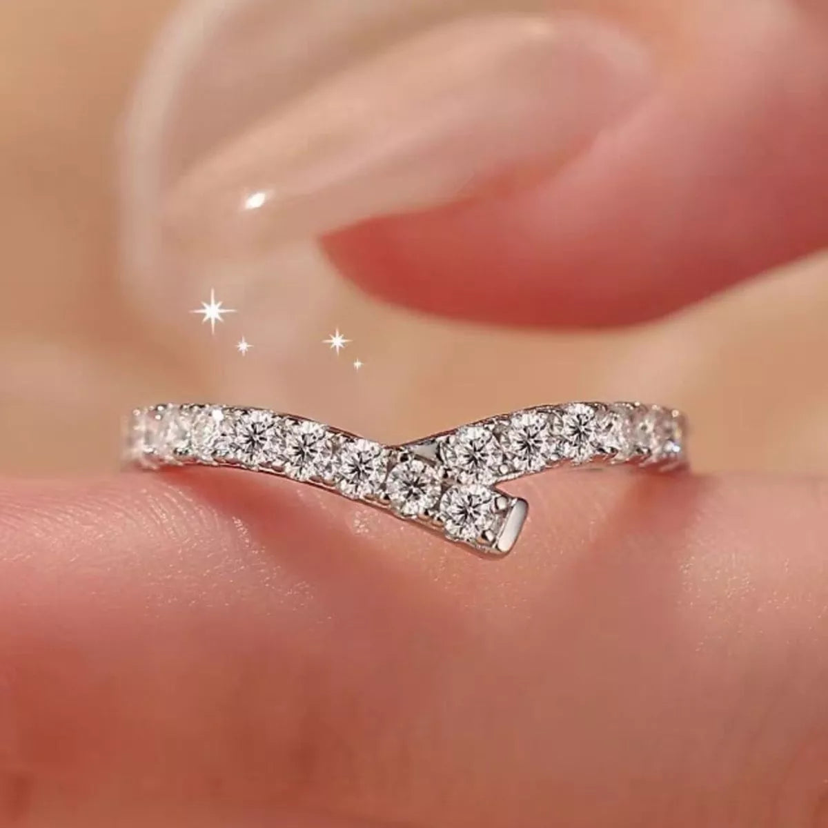 Diamond ring on a finger with a blurred background