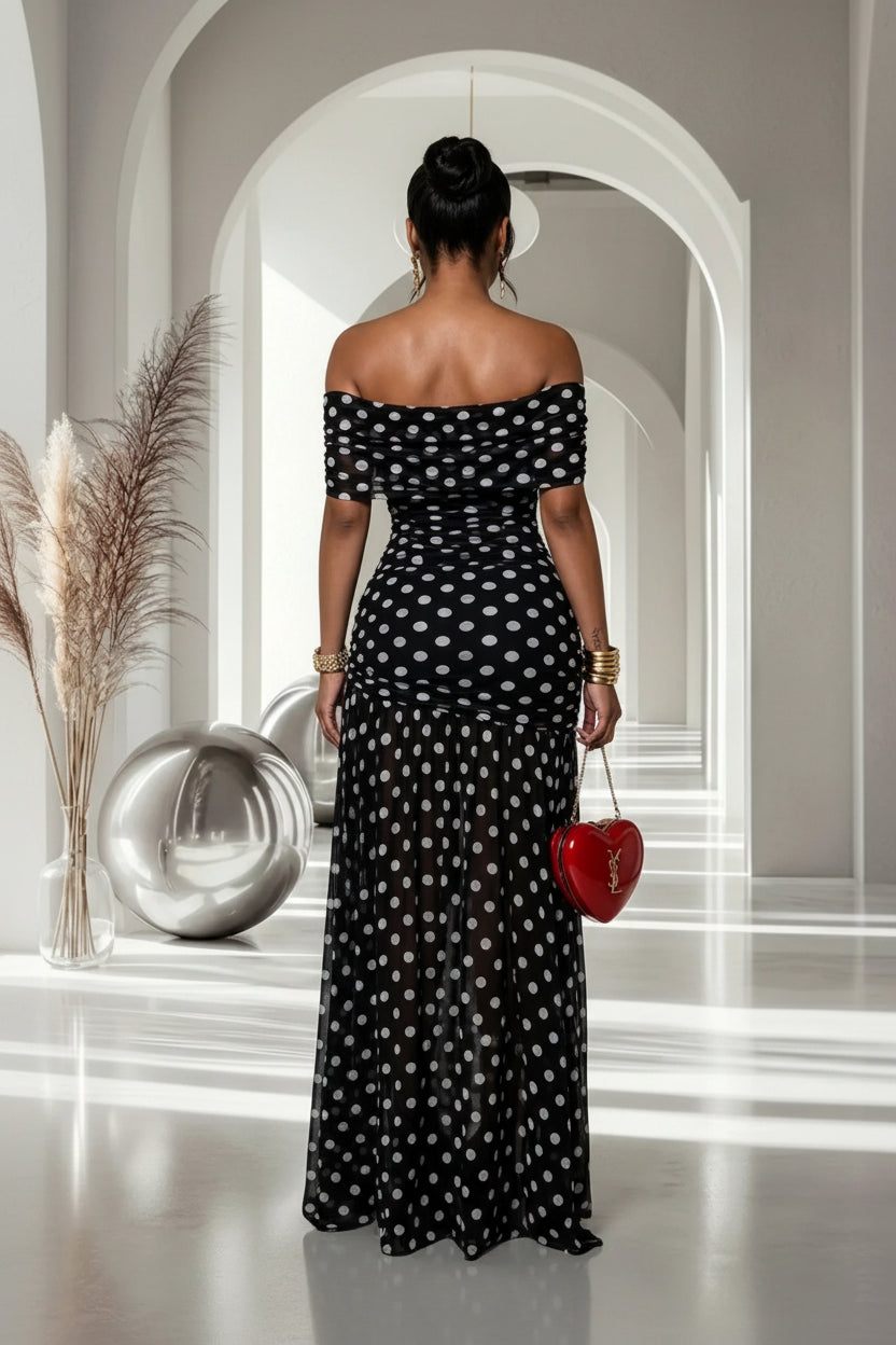 model in polka dot dress with back turned to camera