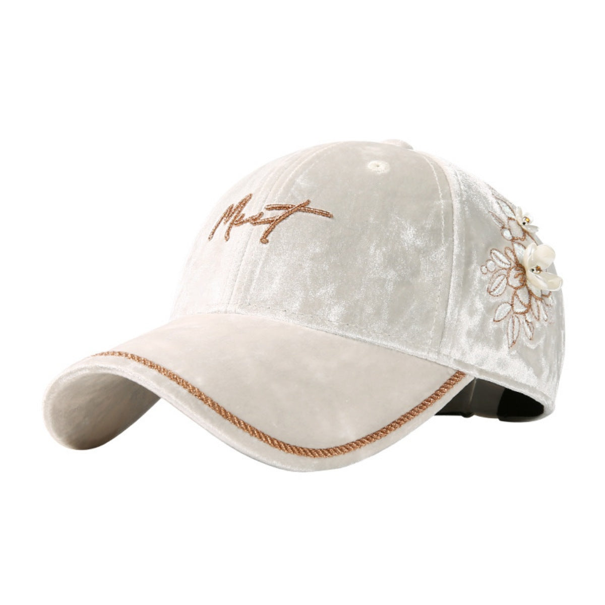 Close-up detail of hand-placed floral embellishments on luxurious velvet cap