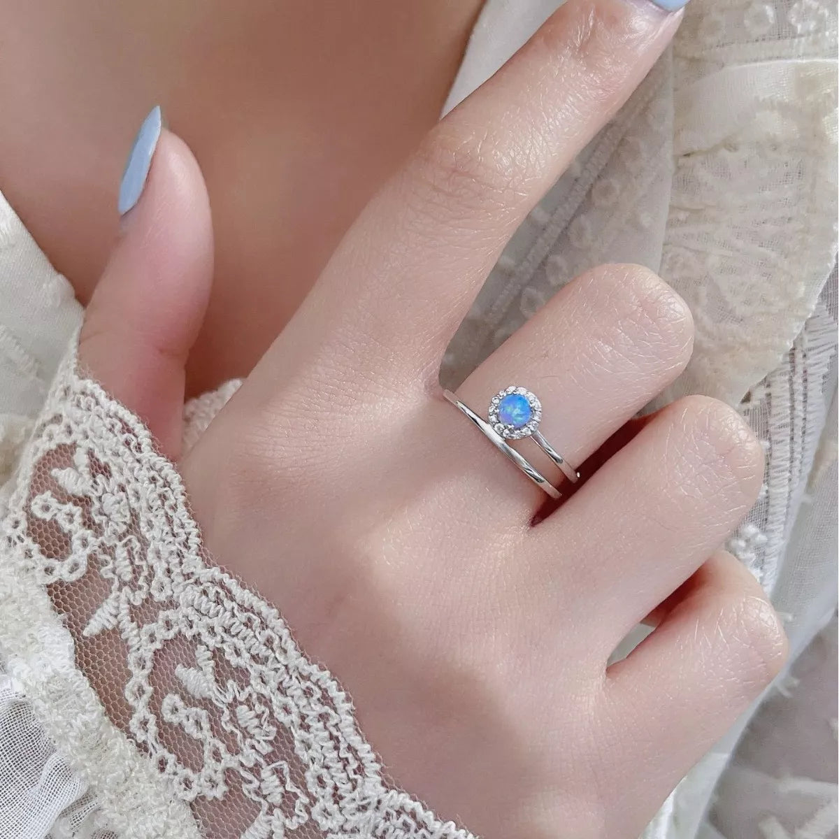Rebellious Gal opal ring platinum plated 925 silver worn close-up on finger natural light