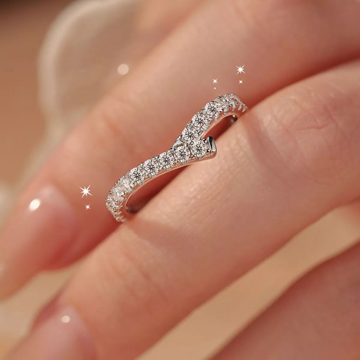 Silver ring with diamonds on a finger