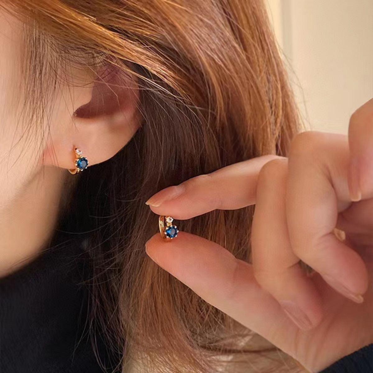 Model wearing Rebellious Gal zircon hoop earrings with rebellious layered jewelry look