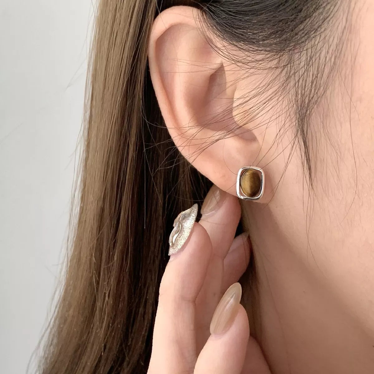 Close-up square tiger eye gemstone studs 925 sterling silver gold plated