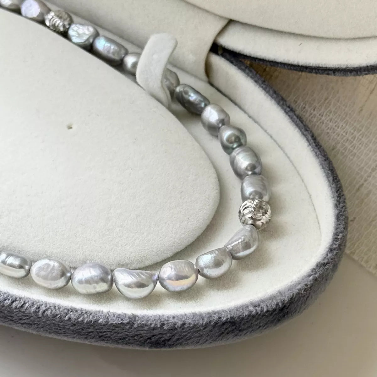 Pearl bracelet on a heart-shaped jewelry cushion