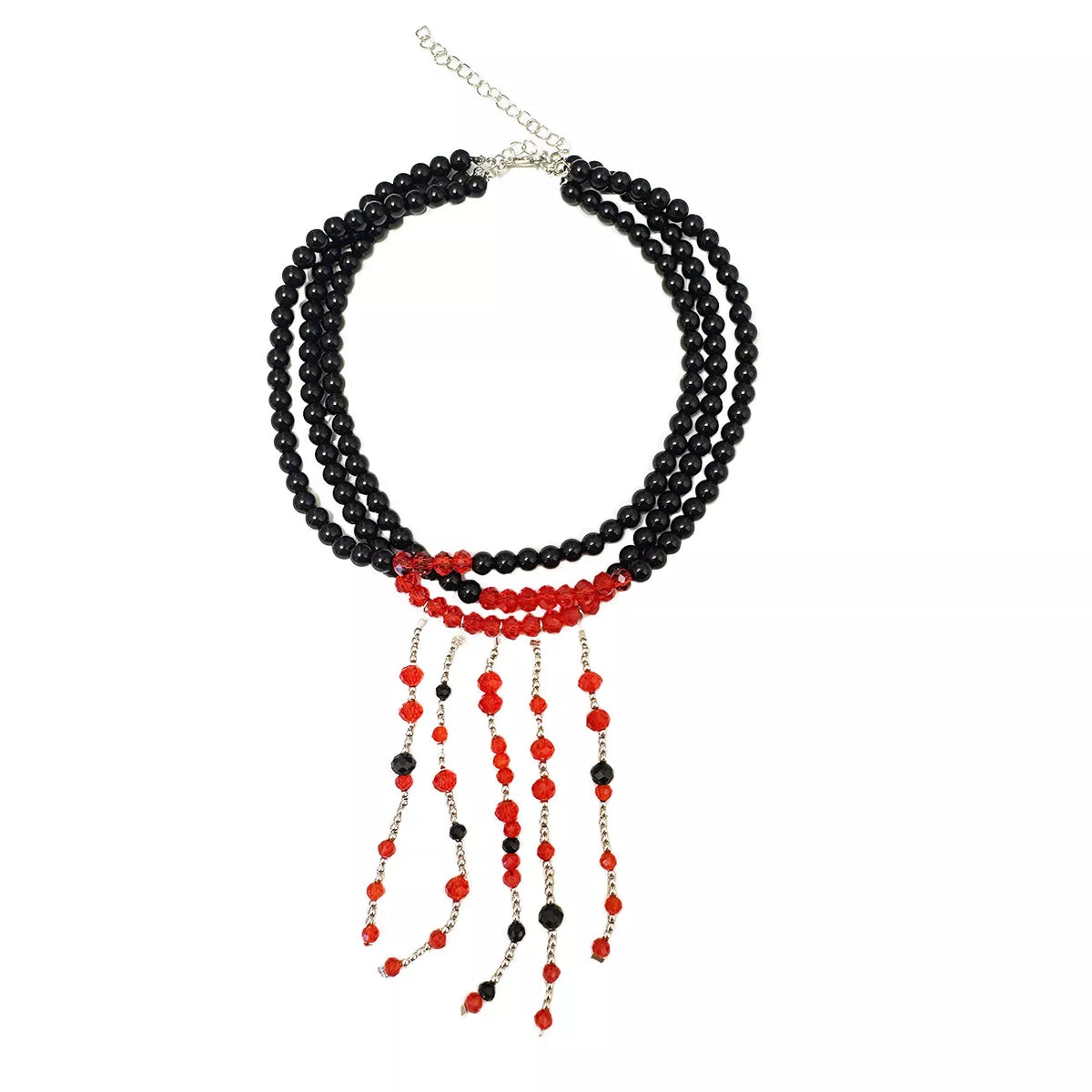 Three-strand black bead choker with red beaded fringe, flat lay on white