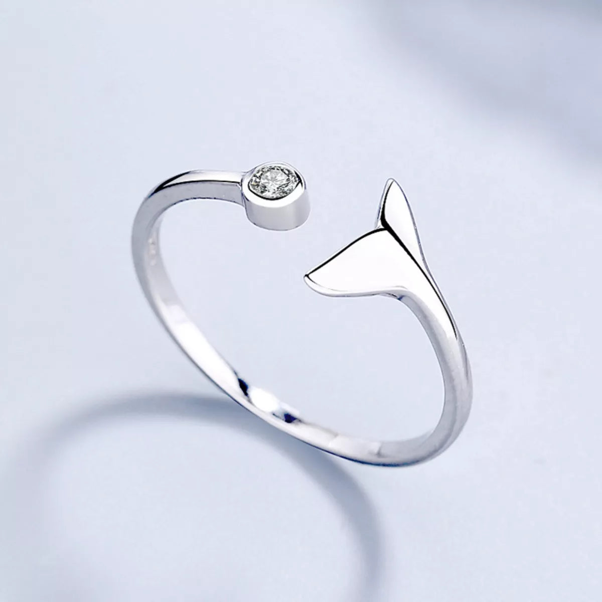 Minimalist styling with whale tail ring and neutral outfit