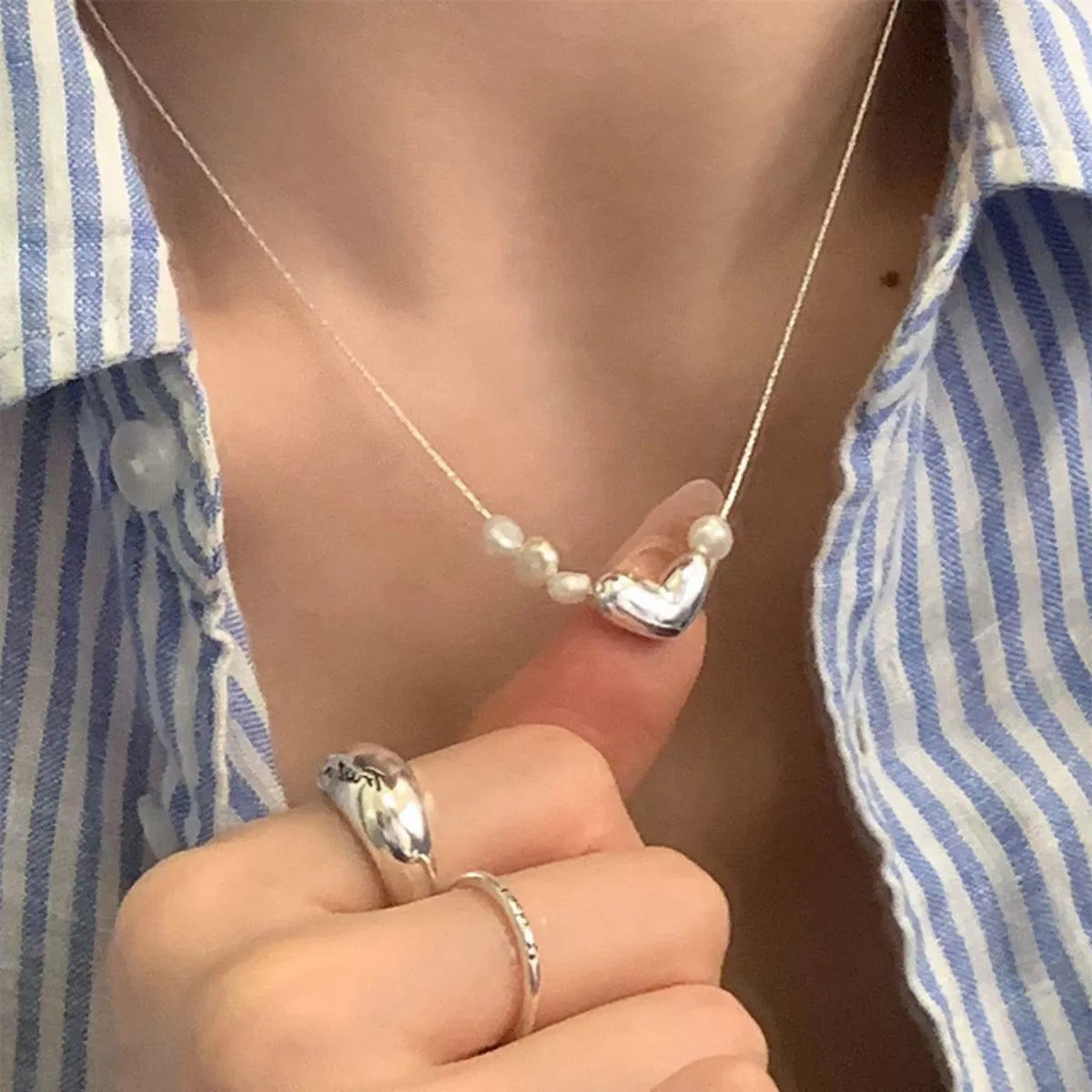 Heart and pearl necklace worn on model