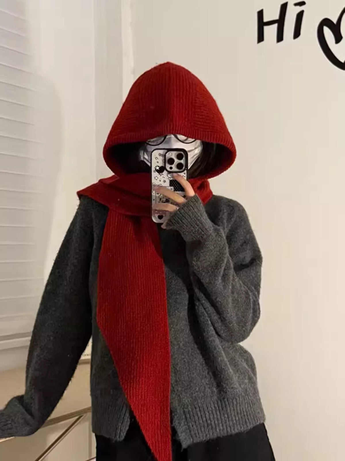 Knitted hat with attached scarf on rebellious woman winter street style 2026