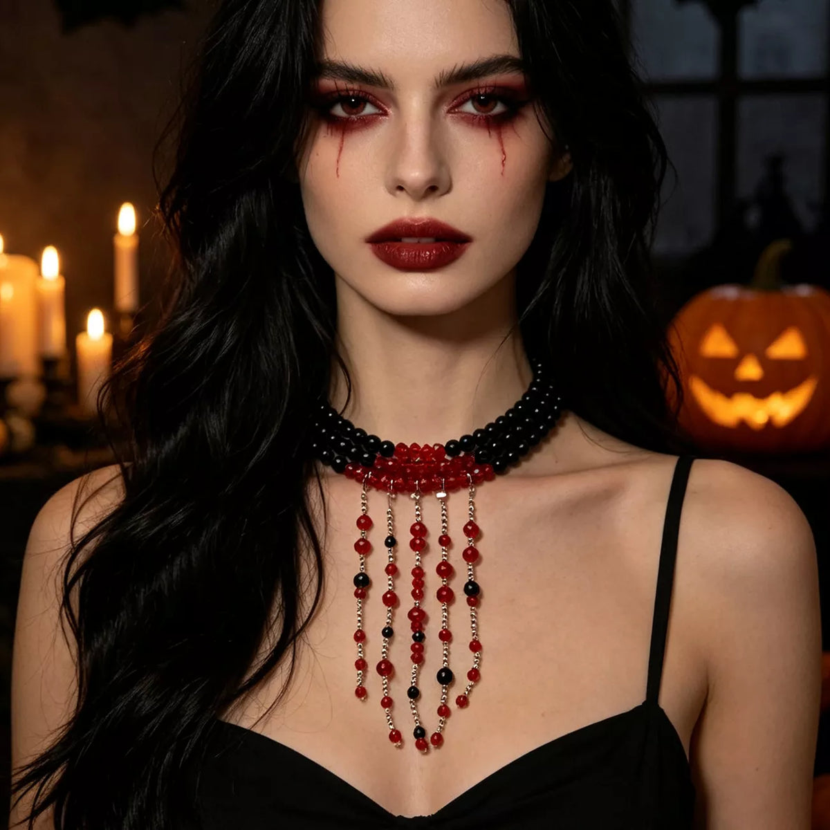 Black bead choker with red and black beaded fringe worn with a black strappy top