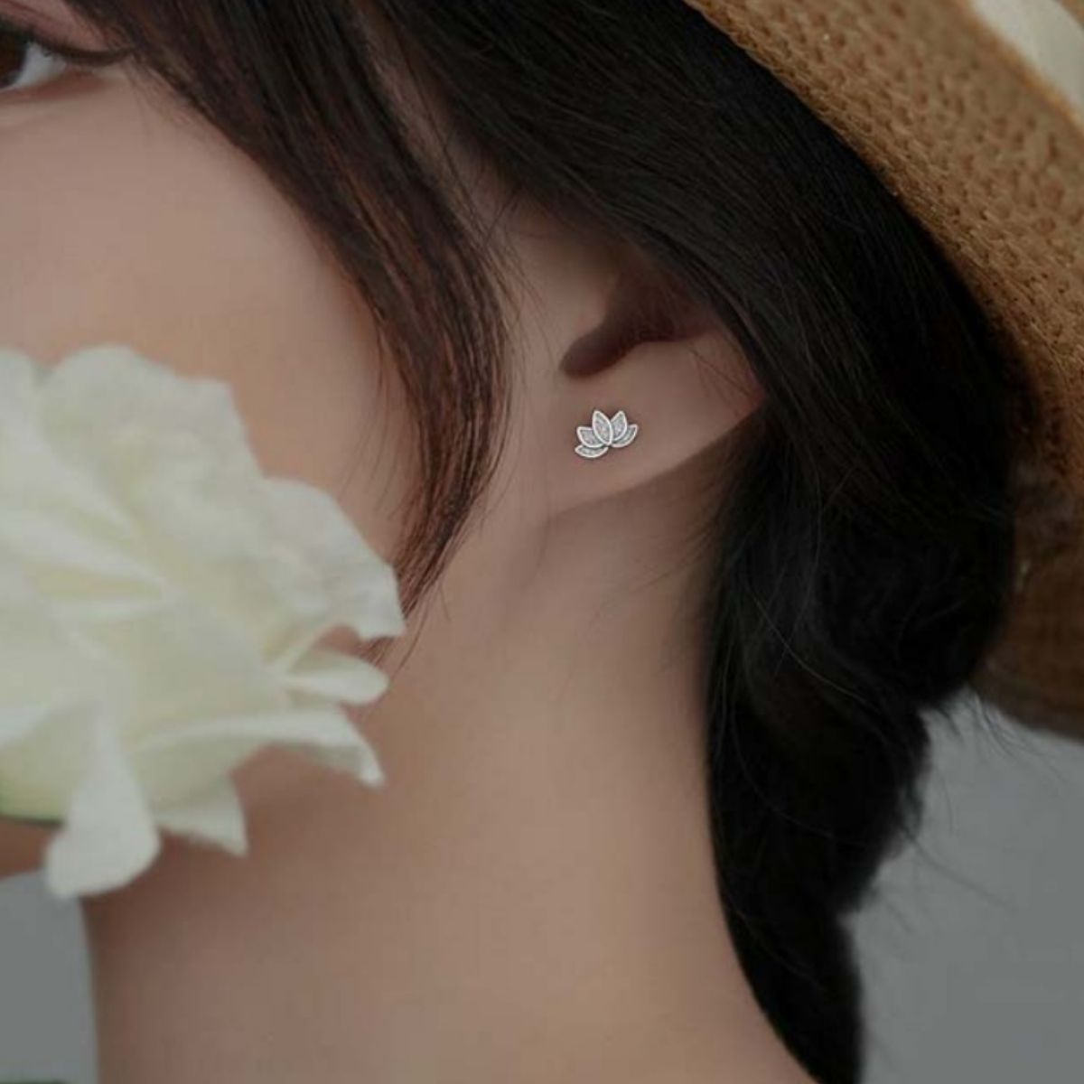 Lifestyle image of model wearing Lotus Flower Stud Earrings