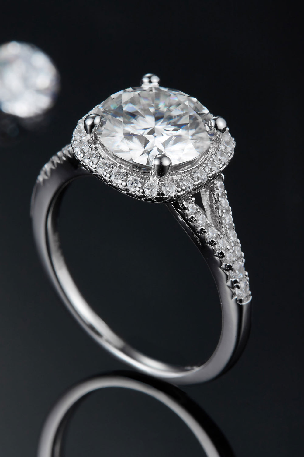 Close-up of 3 carat round moissanite center stone with sparkling halo accents