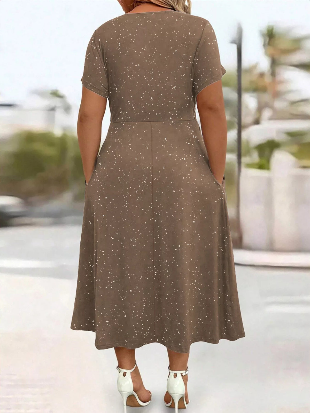 model in brown maxi dress with back to camera
