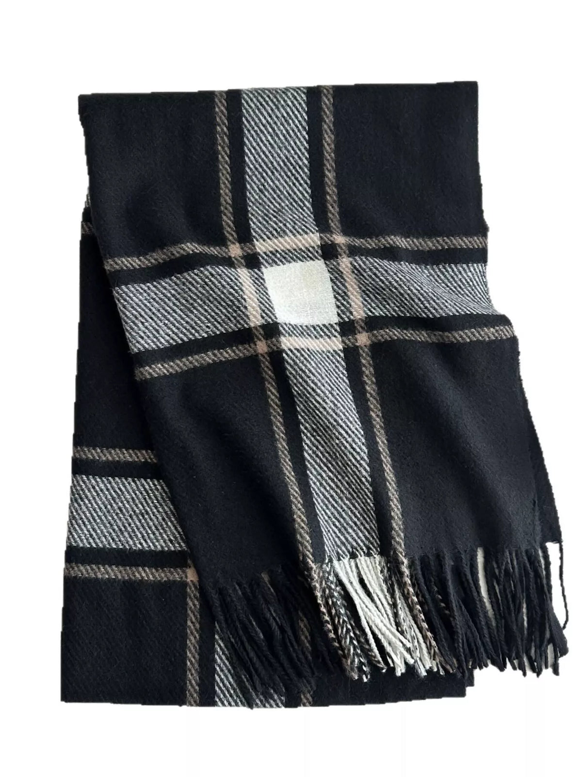 Detail shot of woven plaid texture and fringe tassels on winter scarf