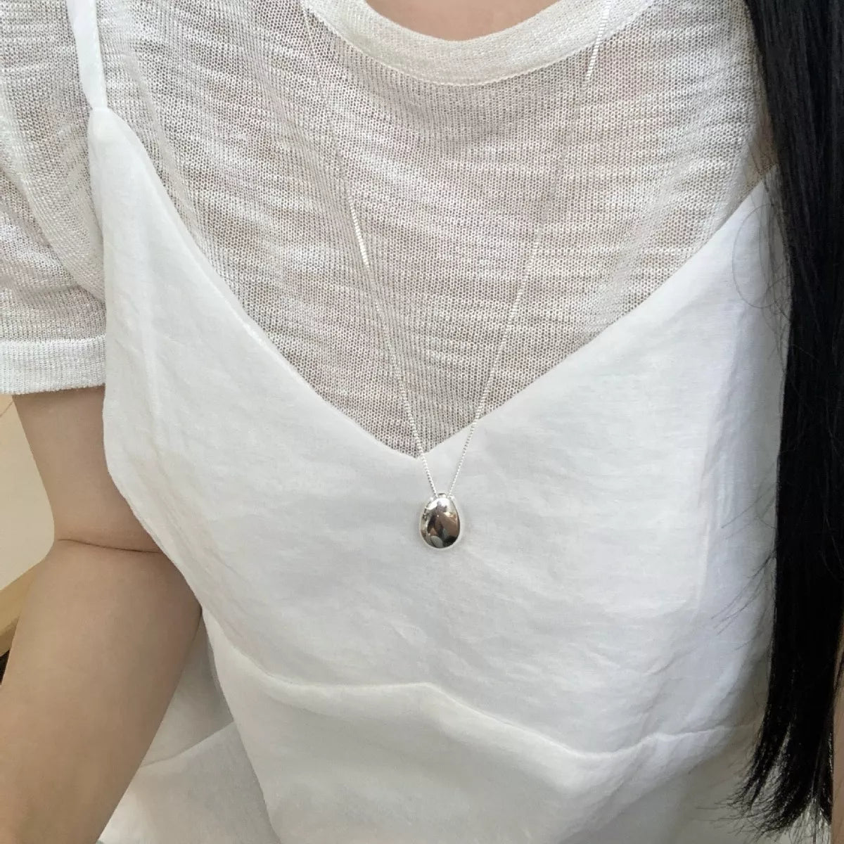 Model wearing Rebellious Gal long sterling silver pendant with rebellious layered look