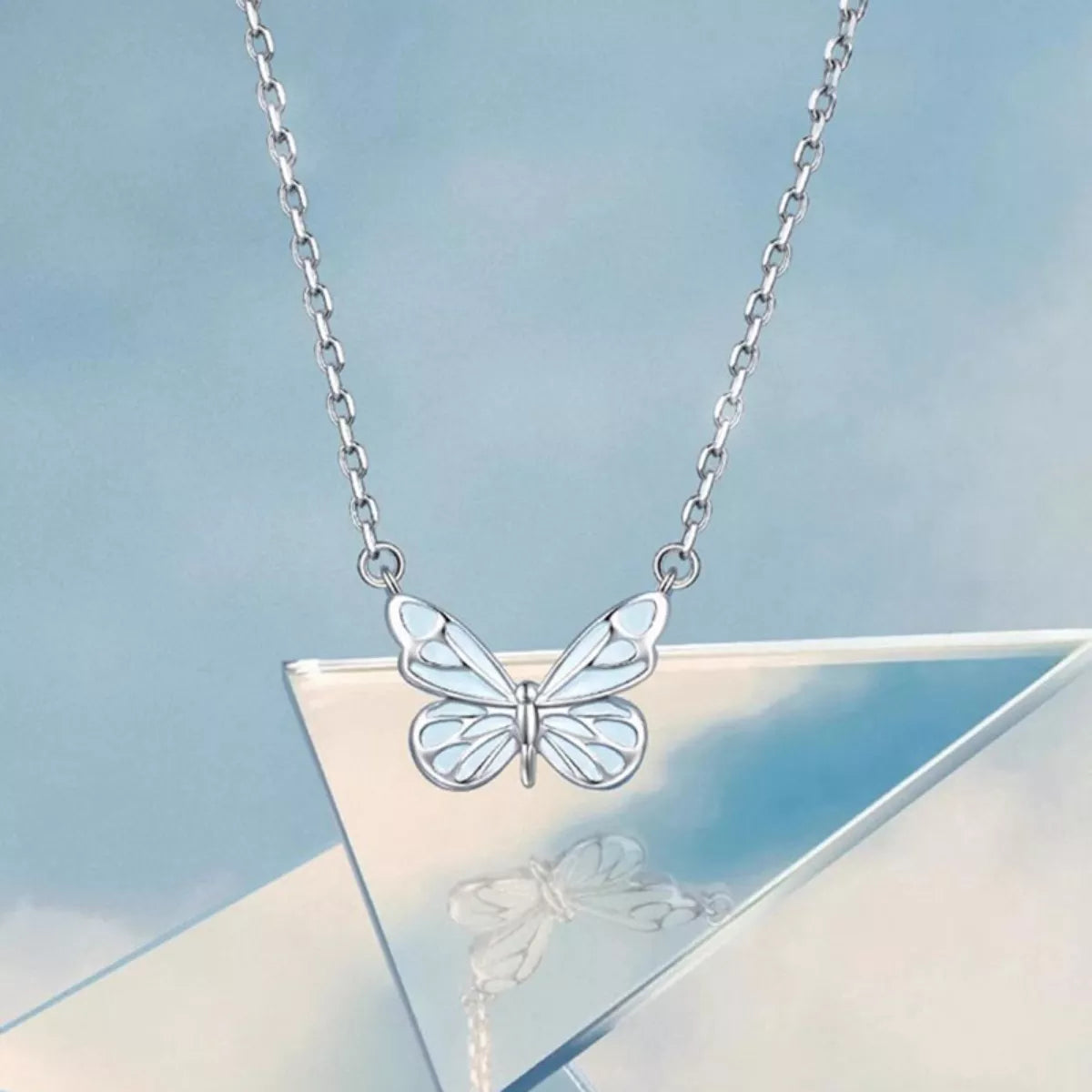 Close-up of resin butterfly pendant on 925 sterling silver chain