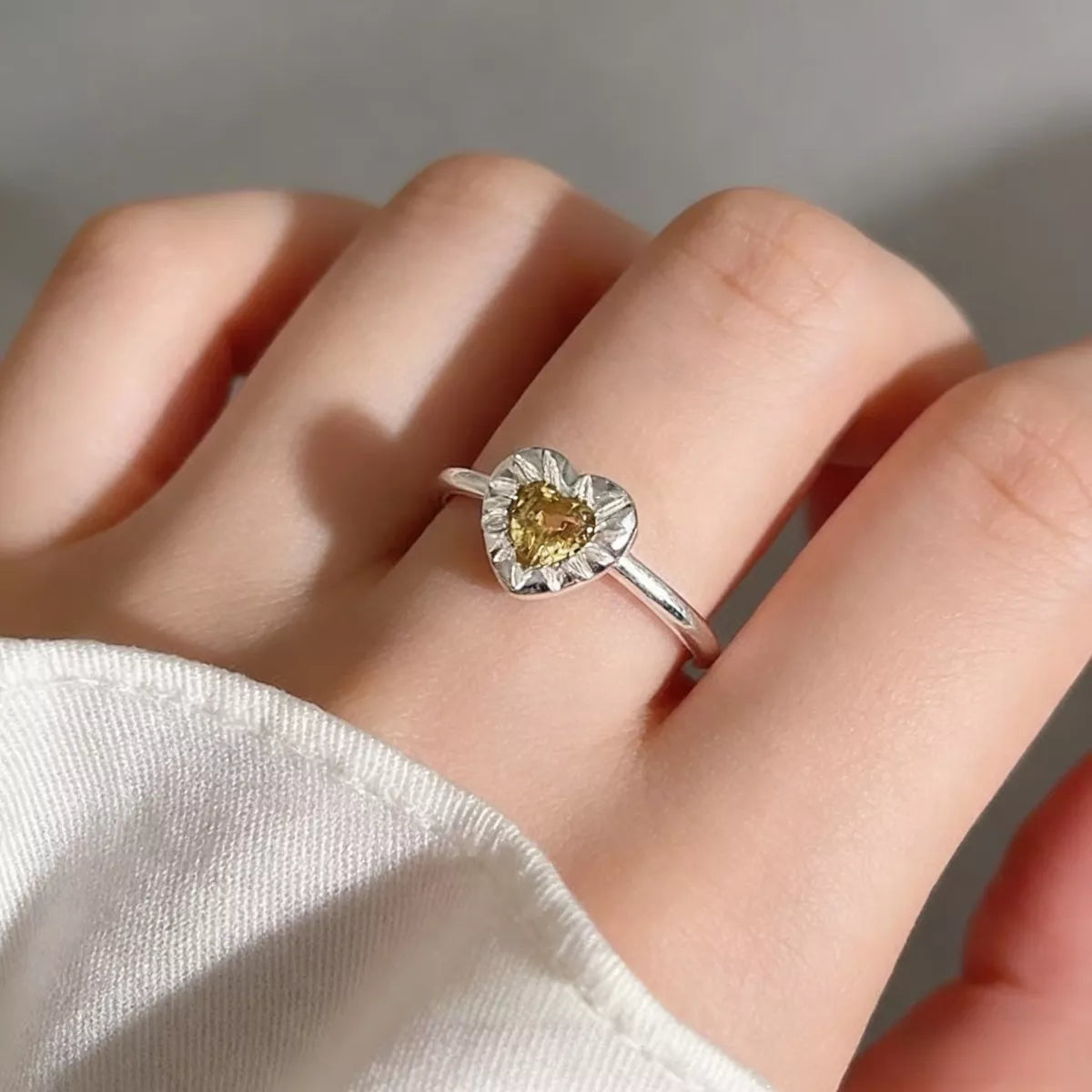 Model wearing Rebellious Gal heart open ring with rebellious layered jewelry