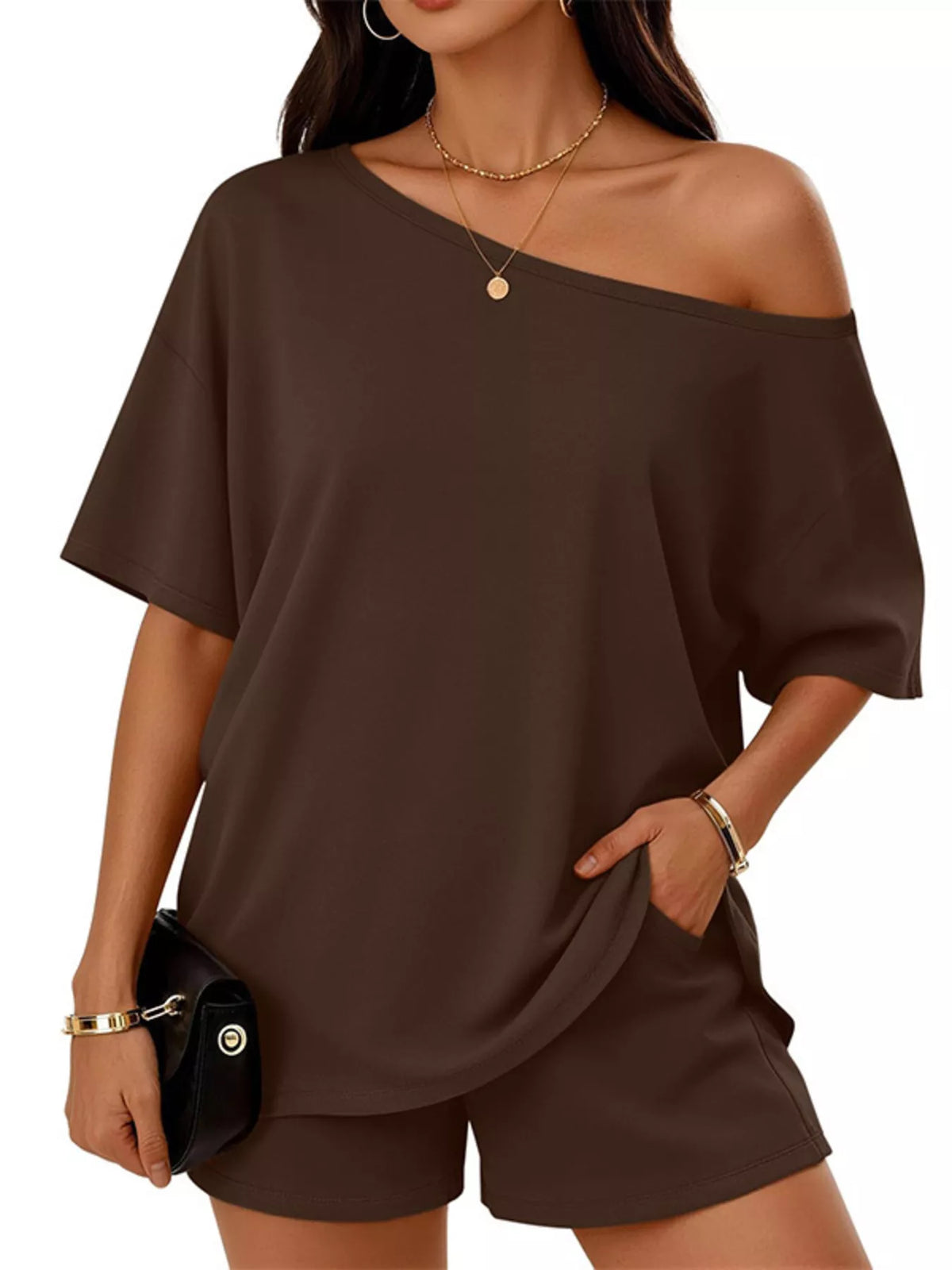 Woman wearing a brown off-shoulder top and shorts set on a white background