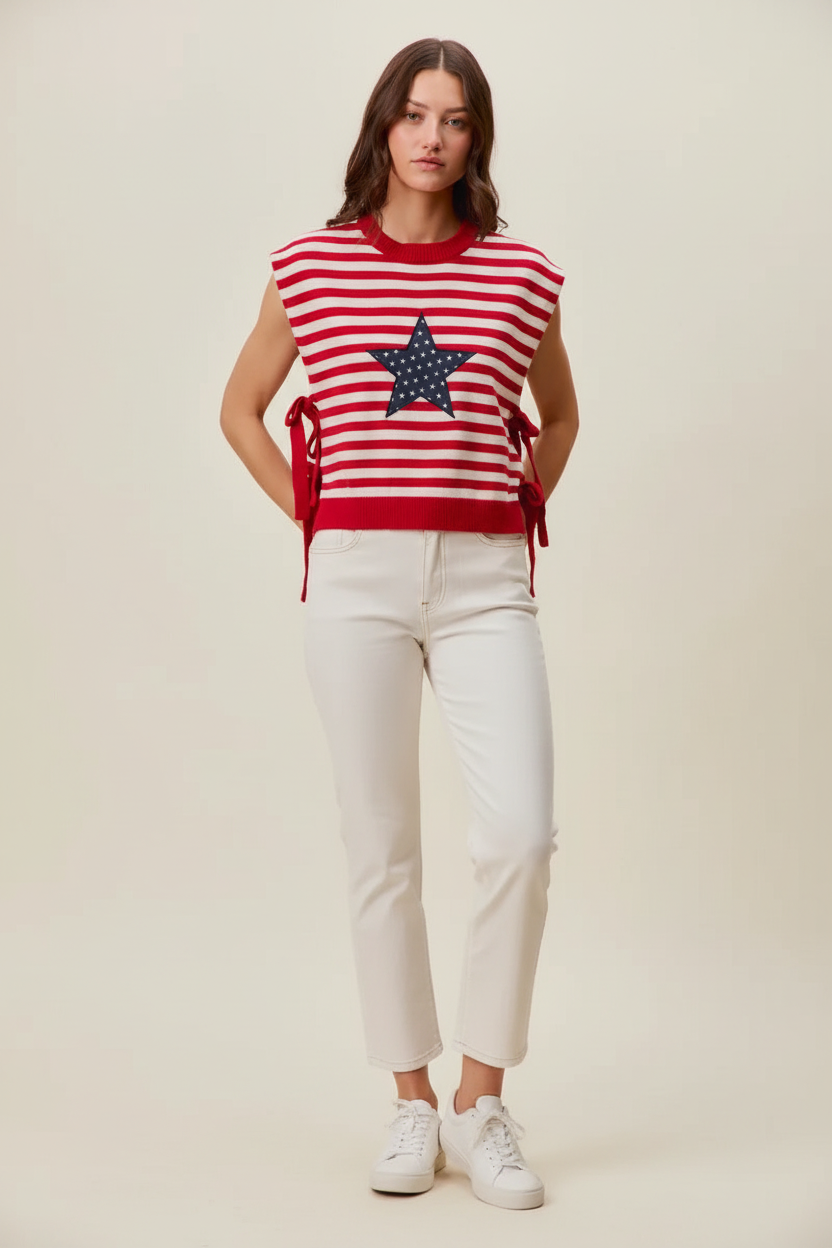 Red and white striped sleeveless top, navy star patch, red side ties, cream trousers