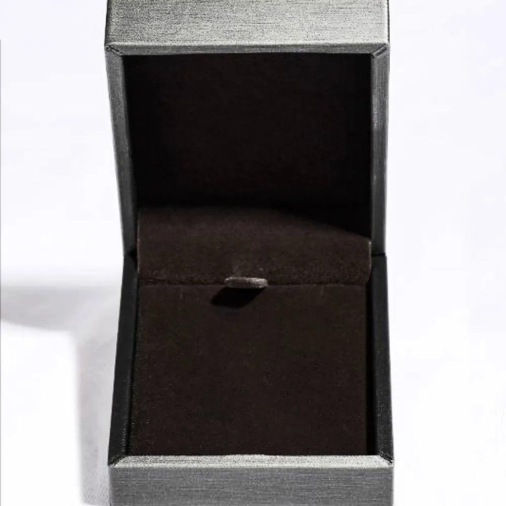 Product shot of moissanite cross necklace arranged neatly with matching box
