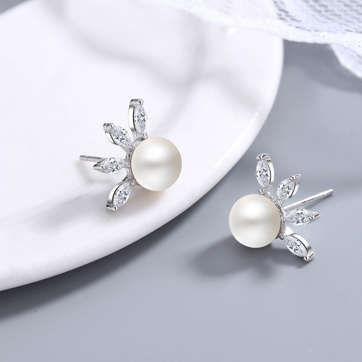 Quiet Power pearl stud earrings pair full view on white background