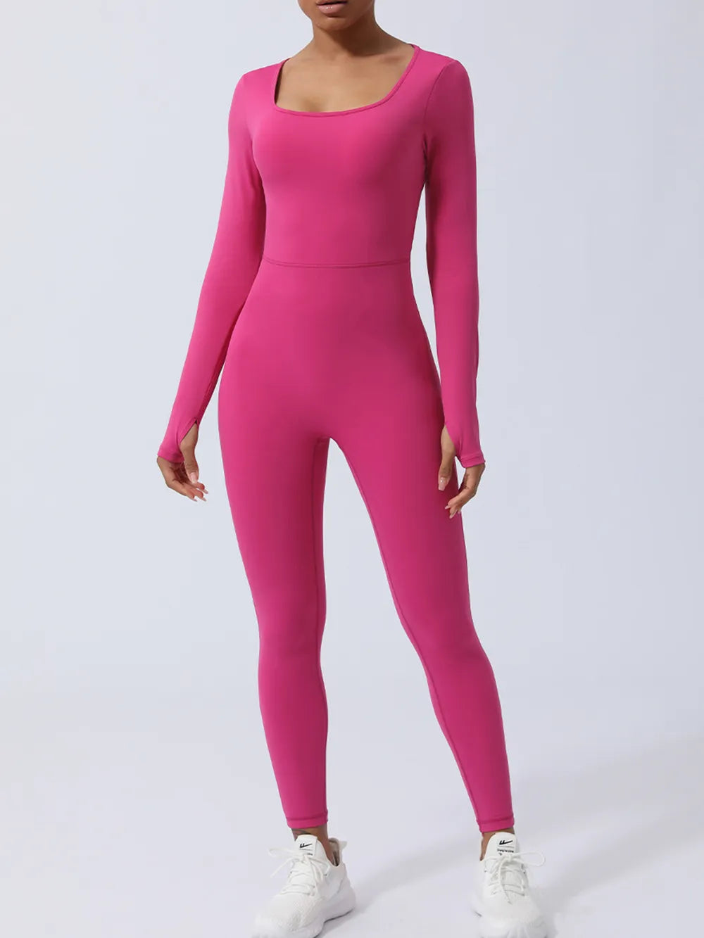 Hot pink version straight to camera, squared neckline above a fitted bodice, feet set apart