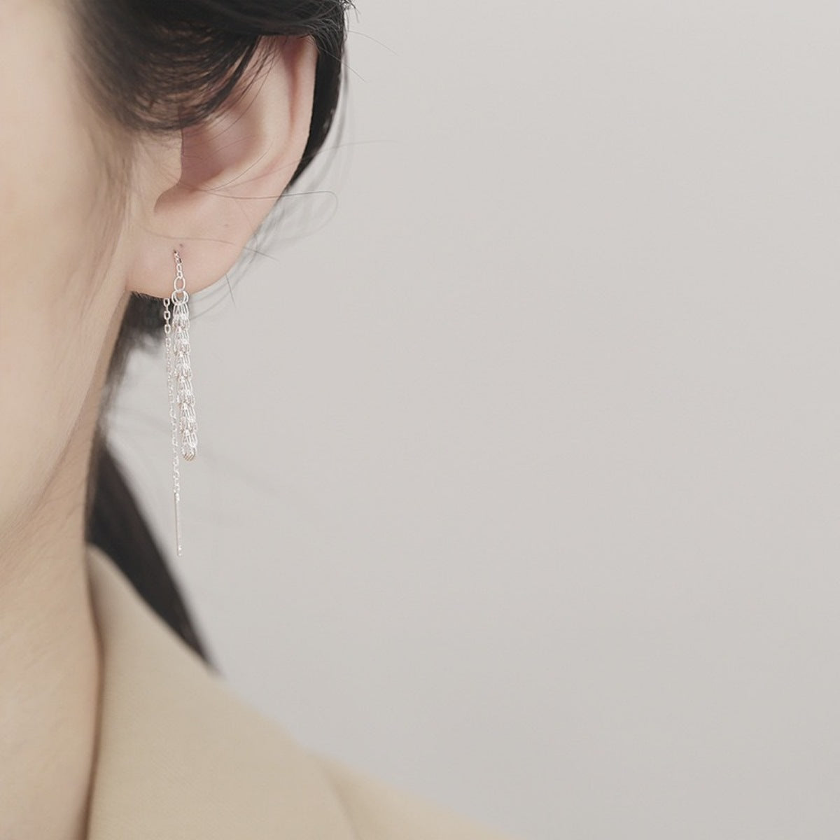 Model wearing Rebellious Gal threader earrings with rebellious layered ear stack