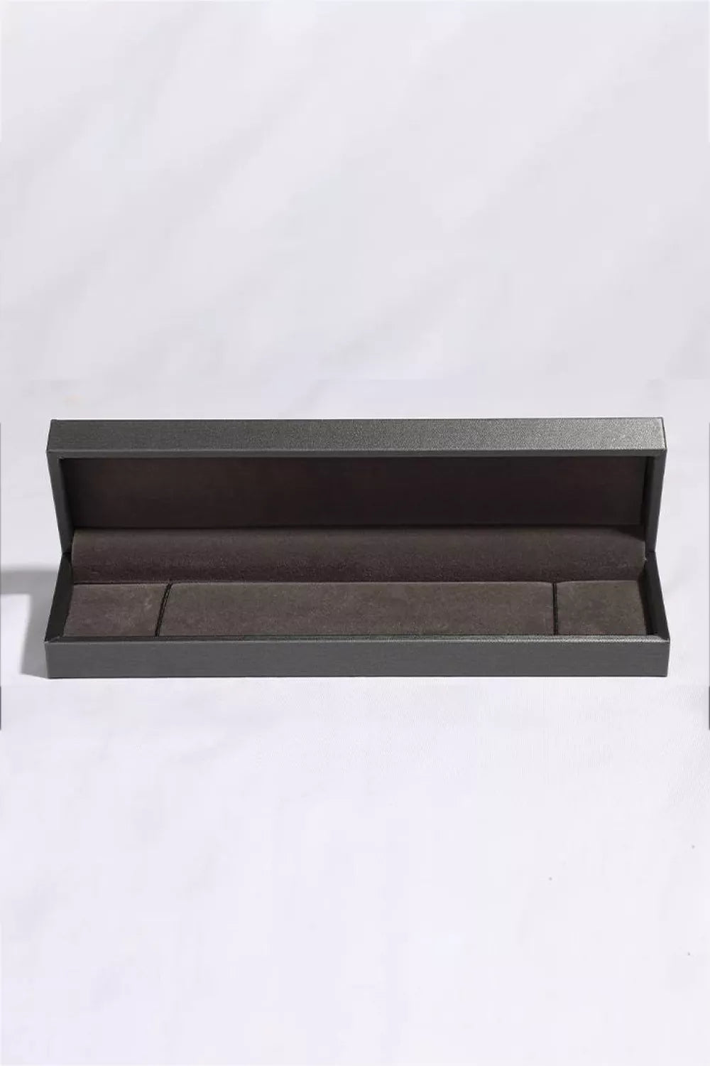 Product shot of 2 carat moissanite bracelet arranged neatly with matching box and certificate