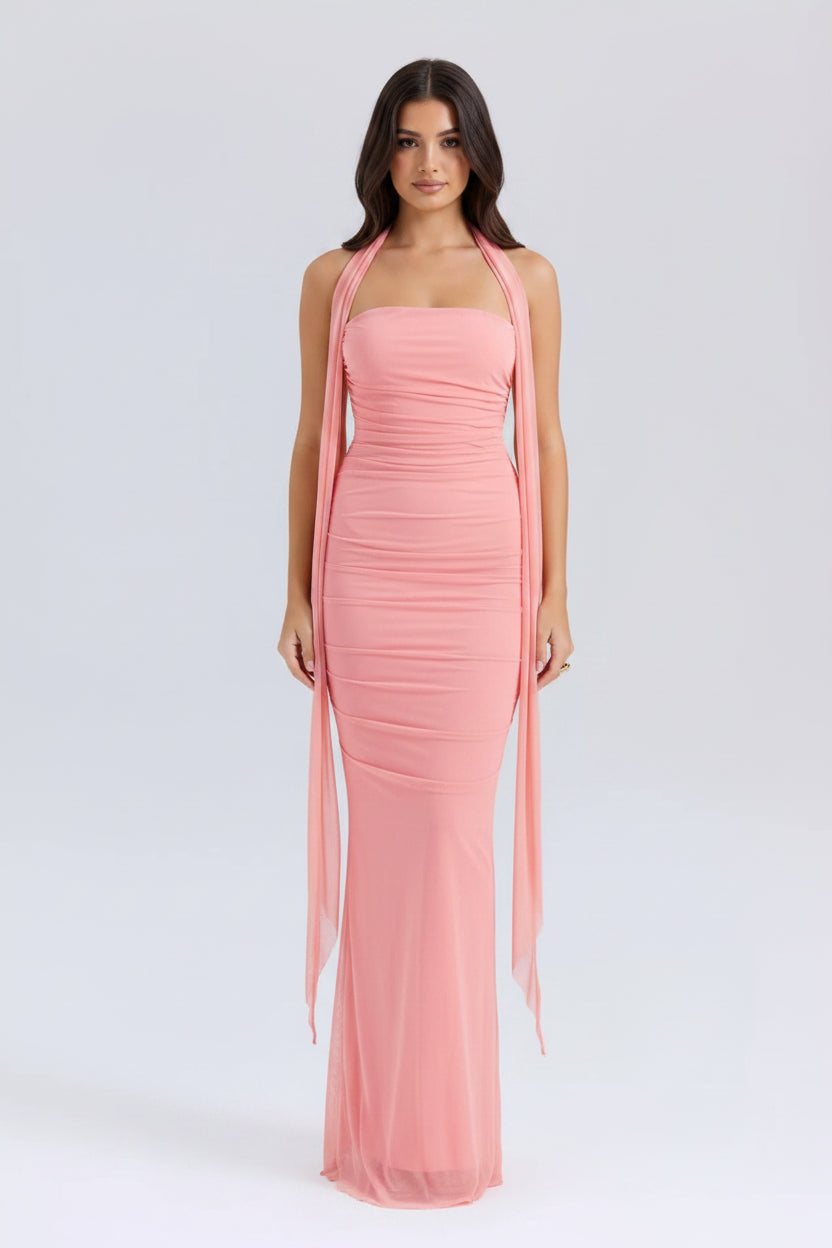 Peach-colored halter neck gown on a white background 